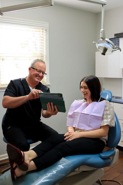 Dr. Arnett and a patient looking a the tablet